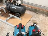 two air compressors sitting on the floor next to each other