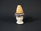 a close up of a figurine with a hat on it ' s head