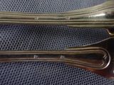 two spoons and a fork sitting on a table