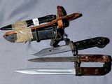 three different types of knives on a white surface