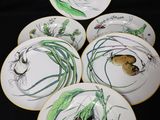 six plates with different designs of vegetables on them on a black surface