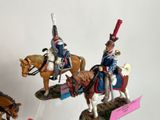 three figurines of men riding horses on display