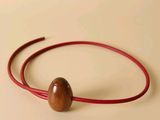 a picture of a bracelet with a wooden bead on it