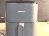 a small air fryer sitting on a wooden table