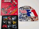two books on a table with a picture of a race car and a picture of a car