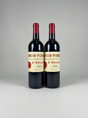 two bottles of red wine sitting next to each other on a table