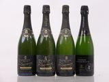 three bottles of champagne are lined up on a table