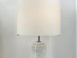 a lamp that is sitting on a table next to a vase
