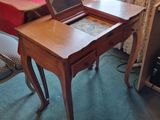a small desk with a laptop on top of it