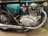 a blue motorcycle parked in a garage with a blue wall