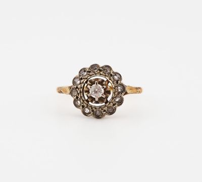 an antique diamond cluster ring in yellow gold and white diamonds