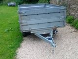 a trailer that is parked on the side of the road