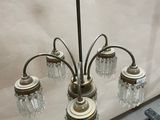 a chandelier that has five lights attached to it