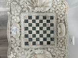 a white and black checkerboard sitting on a table