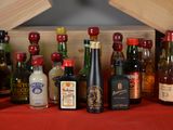 many bottles of alcohol on a red table cloth