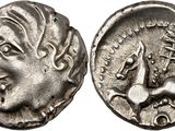 a silver coin with an image of a woman and a bird on it