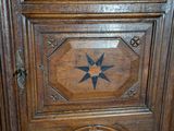 a wooden cabinet with a star design on it