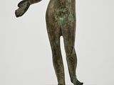 statue of a boy holding a ball on a pedestal