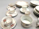 many plates and cups and saucers on the table