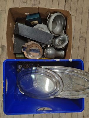 a blue box filled with assorted items on a wooden floor