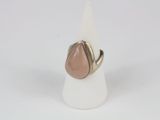 a close up of a ring with a tear shaped stone on it