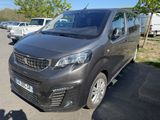 a grey van parked in a parking lot next to other cars