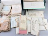 an open box filled with lots of old papers sitting on top of a table