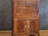 a small wooden cabinet with a door on top of it
