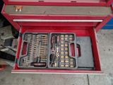 a red tool box with tools in it on the floor