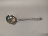 a spoon that is sitting on a white table