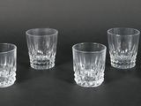 six shot glasses lined up on a black surface