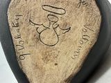 a guitar pick with a drawing on it on a table