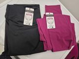 two pairs of pink and black leggings sitting on a white table
