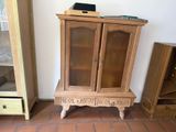 a small wooden cabinet with a laptop on top of it