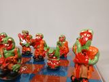 many figurines on a chess board with a blue and red checkered floor