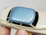 a person holding a toy car in their hand