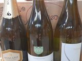 several bottles of wine are sitting in a box on a table