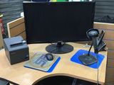 a desk with a computer monitor and a keyboard on it