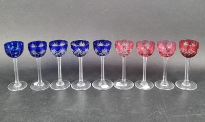 six wine glasses lined up in a row on top of a table