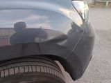 a reflection of a man in a mirror on the side of a car