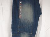 the jeans are hanging on a hanger on the wall