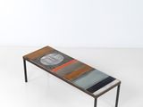 une photo d'une table basse avec un plateau en verre et des pieds en métal