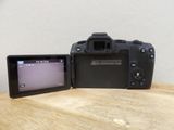 a camera sitting next to a small monitor on a table
