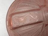 a pink glass bowl with a decorative design on it