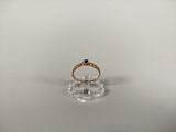 a close up of a gold ring with a black stone on it