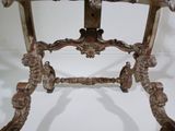 a wooden table with a marble top on a white surface