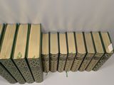 a stack of books sitting on top of a table next to each other