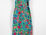 a colorful dress hanging on a hanger on a wall
