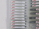 several pens are lined up in a plastic case on a table