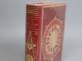 a red book with a gold clock on it